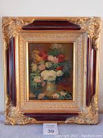Full view of the painting in the ornate frame showing the floral composition and overall condition.