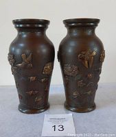 Front view of both vases showing relief decoration of chrysanthemums and sparrows.