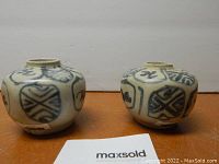 Front view of both jars showing medallion decoration and overall shape