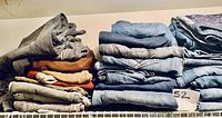 Shelf view showing left and center stacks of folded jeans