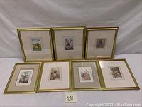 Seven framed flower fairy art prints by Cicely Mary Barker, arranged in two rows with gold frames and white mats.