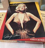Large Marilyn Monroe 5500-piece puzzle in original box showing her in gold dress