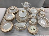Full layout of service pieces including plates, bowls, cups, saucers, serving dishes and teapot