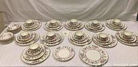 Overview of all pieces laid out on table showing cups, saucers, plates