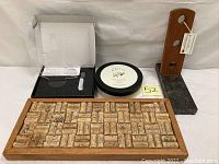 Wine cork art tray, Pottery Barn cheese plates in black round box, granite base with wood vertical wine bottle rack with holes for bottles