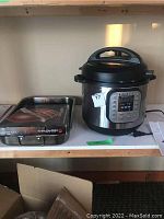 Instant Pot, roasting pan box with knives inside on shelf