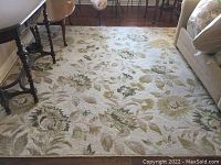 Full view of rectangular rug in room under table and sofa