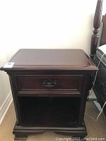 Front view of nightstand showing single drawer and lower open shelf