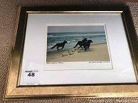 Framed print in gold ornate frame showing three ponies running on a sandy beach with ocean waves.