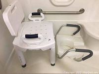 Shower chair and raised toilet seat shown together in a bathtub area. The shower chair has a backrest and padded handles.