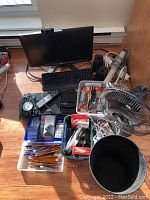 Full overview showing Acer LCD monitor with webcam, keyboard, Bluetooth speakers, fan, lamp, power bars, laser pointer and assorted office supplies.