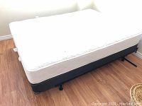 Full view of mattress on box spring and frame