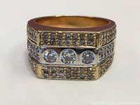 Front view showing three central brilliant diamonds and bead-set single-cut rows