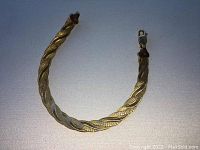 Full view of bracelet showing triple braid pattern and lobster clasp