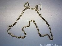 Full view of Figaro chain with both heart pendants laid out