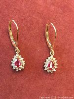 Front view of both earrings displayed on red background