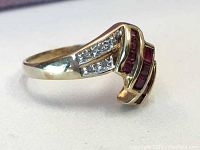 Front angled view of the ring showing V-shaped ruby and diamond setting