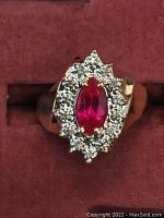 Front view of ring showing marquise synthetic ruby and surrounding diamonds