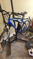 Full side view of blue Trek 3900 mountain bike with knobby tires and accessories attached