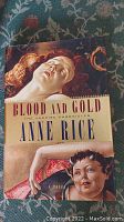 Front cover of the book "Blood and Gold" showing cover art with two figures and title and author text.