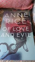 Front cover of 'Of Love and Evil' by Anne Rice showing the dust jacket design with a spiraled serpent and human figure.