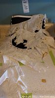 Three hand made white lace collars laid flat on surface