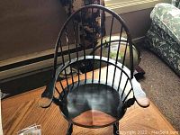 Front view of the miniature Windsor chair showing spindled backrest, armrests and seat.