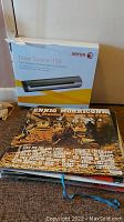 Xerox Travel Scanner 150 box along with a stack of vinyl records including a record by Ennio Morricone.