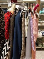 Hanging costumes visible from side showing puff sleeves and chevron skirt for Queen of Hearts