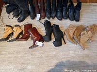 Photo shows all five pairs of boots arranged side by side, in various styles and colors including black, brown, beige, and tan.