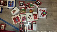 Wide overhead view showing multiple boxed Hallmark Keepsake ornaments featuring Disney, Looney Tunes characters, and Barbie.