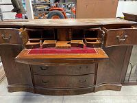 Front view of the base section showing drawers and open fold-down writing surface with small drawers and compartments inside, red felt lining.
