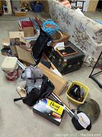 Wide view showing baskets, tins, medical boot, crutches, Heat Seat, and wheelchair canopy on and around black trunk