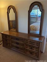 Wood dresser with two arched mirrors sitting on top, showing front and side views.