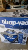 Box showing front view of Shop-Vac wet/dry vacuum packaging with brand and model information.