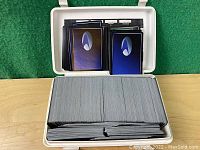 Plastic case open showing hundreds of Star Trek: The Next Generation trading cards arranged inside.