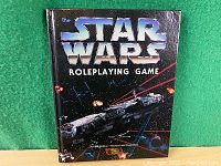 Front cover of the Star Wars Roleplaying Game hardcover book showing the title and space battle artwork