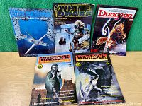 Front view of all five vintage role playing game magazines arranged in standing position showing cover art and titles.