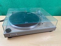 Front angled view of the Pioneer turntable with dust cover closed showing overall condition and branding.