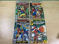 Photo showing four Amazing Spider-Man comic books with colorful covers and Spider-Man in action.