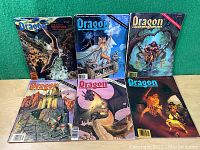 Photo showing six Dragon RPG magazines arranged in two rows of three, depicting various fantasy scenes on covers