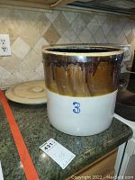 Stoneware crock showing the brown glazed top and off-white base with '3' mark