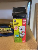 General Purpose Tray on Shelf with a box for GE Energy Smart Light Bulb and blue ratchet strap tiedown.