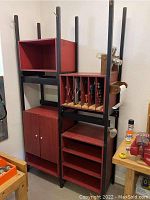 Overall view of handmade all-wooden garage cabinet showing open shelves, closed double-door cabinet at bottom, and slide-out storage slots on side.