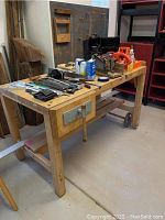 Full view of wooden workbench with tools on top (tools not included)
