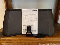 Front view of Kicker Amphitheater speaker dock with manual and remote