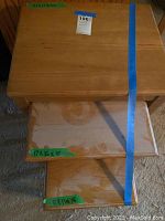 Top view of the largest nesting table showing dimensions tagged with green tape: 24 x 18 x 22 inches and medium table underneath labeled 17 x 16 x 18.