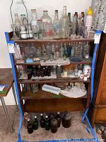 Front view of vintage oak bookcase with multiple shelves and various items displayed, showing construction and finish.