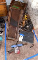 Photo of vintage wooden shoe shining kit with shoe trees, brushes, and polishing box.