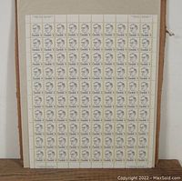 Full shot of entire stamp sheet displayed vertically with full margins and visible plate blocks